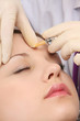 A young beautiful woman having an injection, closeup