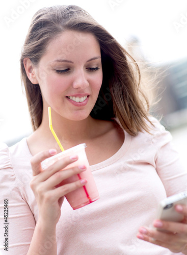 Photo: Woman enjoying a milkshake Woman enjoying a milkshake