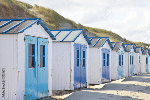 Photo: Dutch little houses on beach in De Koog Texel, The Netherlands Dutch little houses on beach in De Koog Texel, The Netherlands