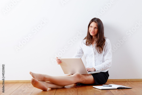 Photo: business woman working at home with laptop business woman working at home with laptop