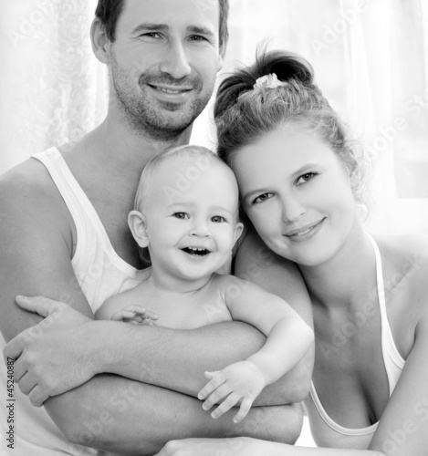 Photo: Happy young family with baby Happy young family with baby