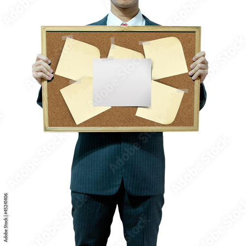 Photo: Business man holding cork board on the background Business man holding cork board on the background