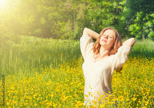 Photo: beautiful young woman enjoying the summer sun beautiful young woman enjoying the summer sun