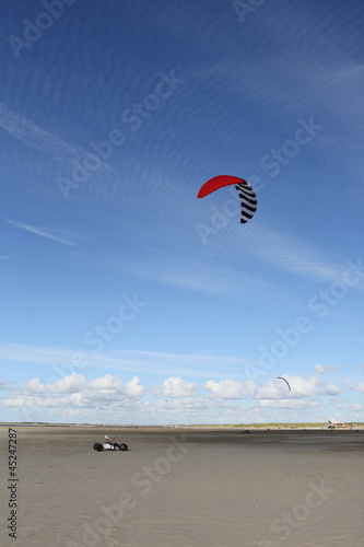 Photo: kite buggy parakarting with cirrus clouds and blue sky kite buggy parakarting with cirrus clouds and blue sky