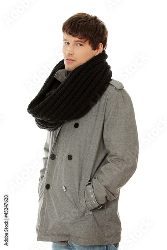 Photo: Portrait of handsome man in scarf and coat. Portrait of handsome man in scarf and coat.