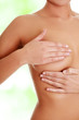 Photo: Woman examining her breast Woman examining her breast