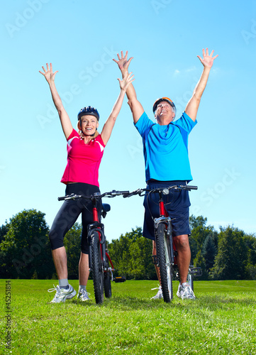Photo: Happy senior couple cyclist. Happy senior couple cyclist.