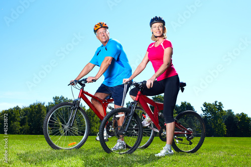 Photo: Happy senior couple cyclist. Happy senior couple cyclist.