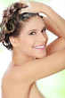 Woman with attractive smile soaping her head
