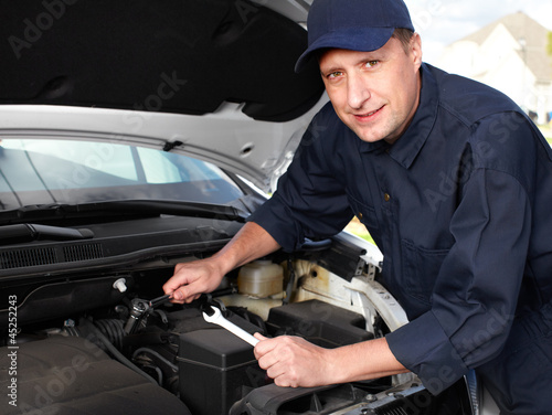 Photo: Professional auto mechanic. Professional auto mechanic.