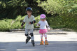 Photo: two happy children on roller blades outdoors two happy children on roller blades outdoors
