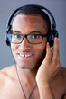 Young black man listening to music in headphones Young black man listening to music in headphones