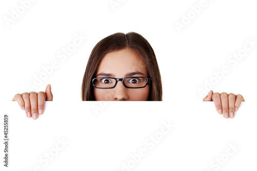 Photo: Shocked woman holding blank board Shocked woman holding blank board
