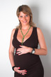 beautiful pregnant woman holding her belly