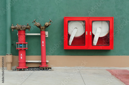 Photo: Hydrant with water hoses and fire extinguish equipment Hydrant with water hoses and fire extinguish equipment