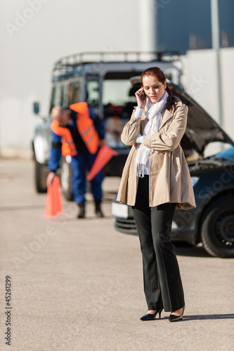 Photo: Woman on the phone after car breakdown Woman on the phone after car breakdown