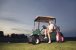 Golfer sitting in golf cart at twilight.