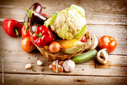 Photo: Healthy Organic Vegetables on a Wood Background Healthy Organic Vegetables on a Wood Background