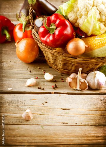 Photo: Healthy Organic Vegetables on a Wood Background Healthy Organic Vegetables on a Wood Background
