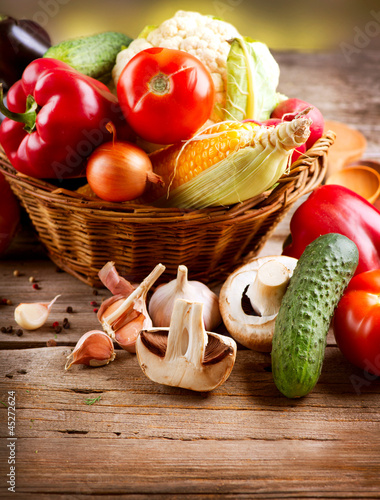 Photo: Healthy Organic Vegetables on a Wood Background Healthy Organic Vegetables on a Wood Background