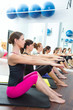 Aerobic Pilates personal trainer in a gym group class