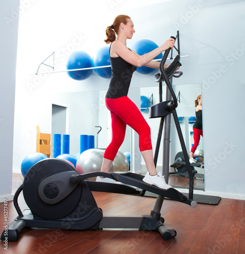 Photo: Aerobics cardio training woman on elliptic crosstrainer Aerobics cardio training woman on elliptic crosstrainer