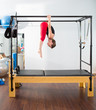 Pilates aerobic instructor woman in cadillac