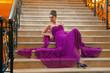 woman in a long dress lying on the stairs