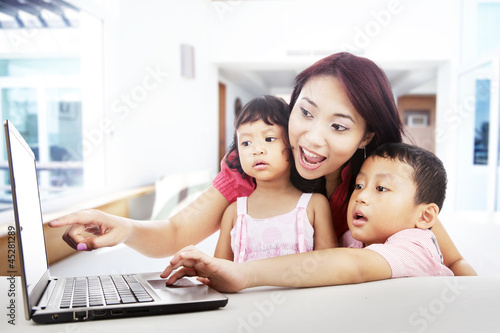 Photo: Enjoying entertainment on laptop at home Enjoying entertainment on laptop at home