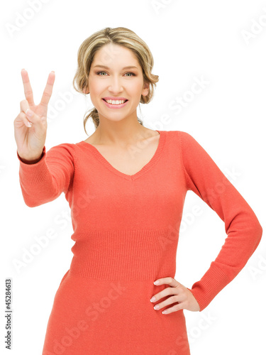 Photo: young woman showing victory sign young woman showing victory sign