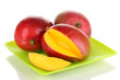Ripe appetizing mango on green plate isolated on white