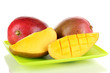 Ripe appetizing mango on green plate isolated on white