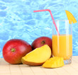 Ripe appetizing mango on woven napkin on water background