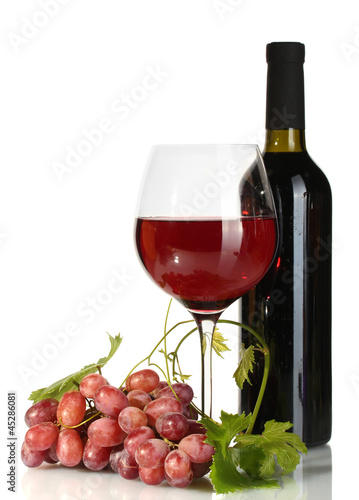 Photo: bottle, glass of wine and ripe grapes isolated on white bottle, glass of wine and ripe grapes isolated on white