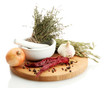dried herbs in mortar and vegetables, isolatrd on white