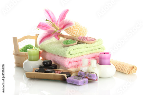 Photo: beautiful spa setting with lily isolated on white beautiful spa setting with lily isolated on white