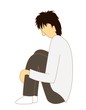 膝を抱える男性