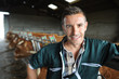 Portrait of smiling breeder in barn