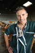 Portrait of smiling breeder in barn
