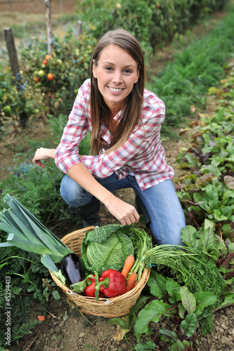 Photo: Woman knelt in vegetable garden Woman knelt in vegetable garden