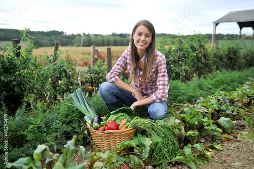 Photo: Woman knelt in vegetable garden Woman knelt in vegetable garden