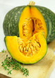 Sliced green pumpkin with thyme sprigs