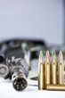 Foto: Close up of rifle and bullets on white background Close up of rifle and bullets on white background