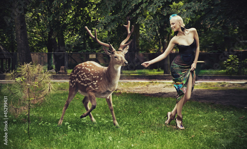 Photo: Young blonde lady running with deer Young blonde lady running with deer