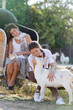 two young happy women with cat and goat on farm outdoor portrait