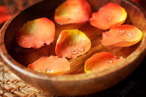 Photo: Close up of rose petals in a wooden bowl Close up of rose petals in a wooden bowl