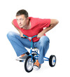 Man on a children's bicycle on white background