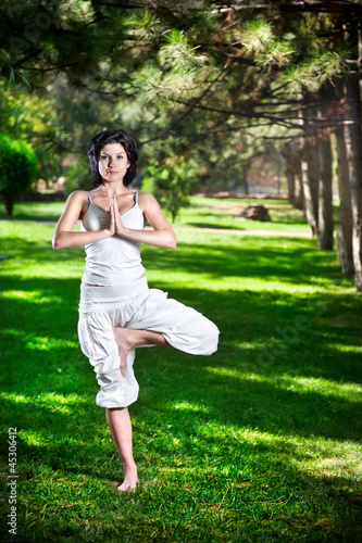 Photo: Yoga tree pose in park Yoga tree pose in park