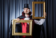 Magician with photoframe in studio