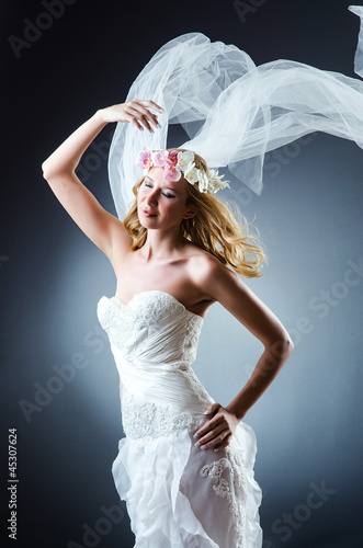 Photo: Bride in white dress in studio Bride in white dress in studio